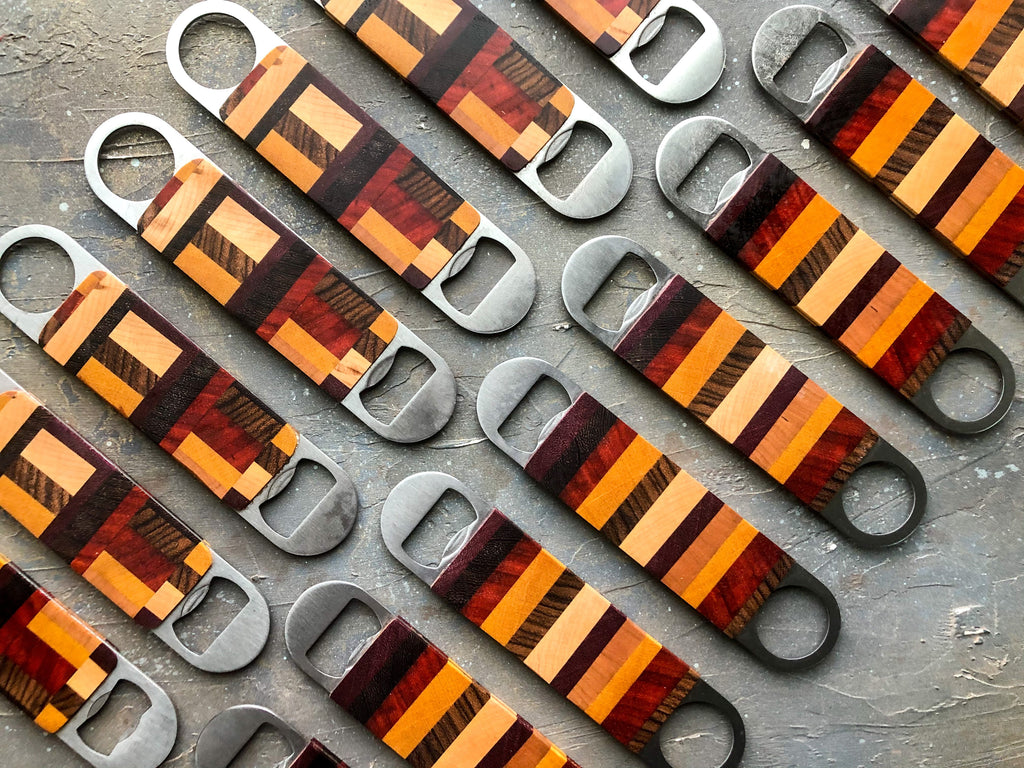 exotic wood bottle openers displayed on an angle